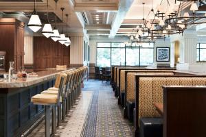 a restaurant with a row of tables and chairs at Little America Hotel Salt Lake City in Salt Lake City