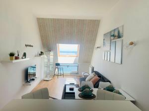a living room with a couch and a table at Apartamentos LAMAROSA -ATICO ,Vistas al Mar Cantabrico PARKING in Burela de Cabo
