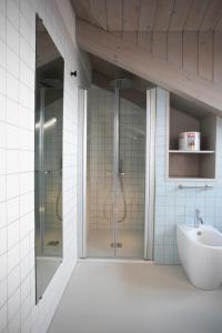 a bathroom with a glass shower and a sink at Cibrario Cit Apartment_Square in Turin