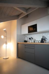 a kitchen with a counter and a lamp in a room at Cibrario Cit Apartment_Square in Turin
