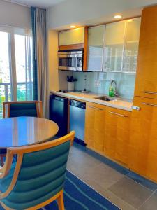 a kitchen with a table and a table and chairs at Ala Moana 1826 condo in Honolulu