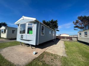 a tiny house is parked in a yard at The Populars, 18 in Rhyl