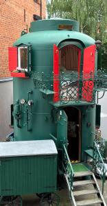 a green and red train engine with a platform at City-Kesselhaus-Stendal in Stendal