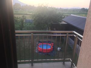 a balcony with a red frisbee in the grass at Cozy 2 bedroom apartment in Sarajevo