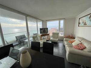a living room with a couch and a table with a laptop at Neohaus vista insuperable in La Serena