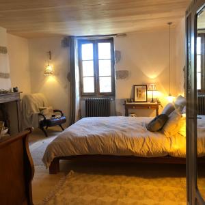 a bedroom with a bed and a window at Mas d’Aubrac in Limogne-en-Quercy