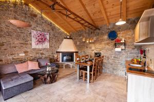 a living room with a couch and a stone wall at Rašpor in Rašpor