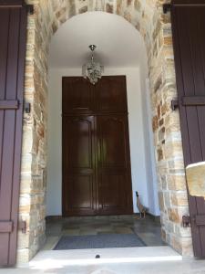 an archway with a large wooden door in a building at Ground floor stylish french holiday home in Arnac-Pompadour