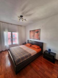 a bedroom with a bed and a ceiling fan at Baby Blue Apartments in Bar