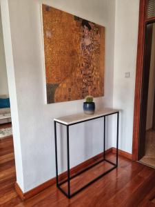 a table in a room with a painting on the wall at Baby Blue Apartments in Bar