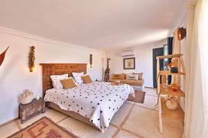 a bedroom with a large bed and a couch at Riad Anyssates in Marrakesh