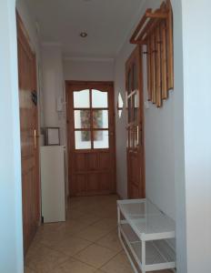 a kitchen with a refrigerator and a door with a window at Apartament z Widokiem na Śnieżkę in Jelenia Góra
