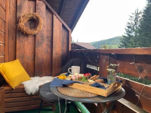 a table on a balcony with a bowl of food at Apartman BlackBerry Tale in Tale