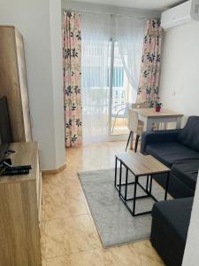 a living room with a couch and a table at Apartamento San Pascual, 289 in Torrevieja