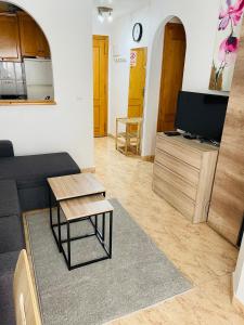 a living room with a couch and a table and a tv at Apartamento San Pascual, 289 in Torrevieja