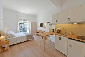 a kitchen and living room with a bed and a table at Estia Hydra in Hydra