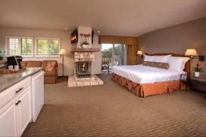 a bedroom with a bed and a fireplace at Horizon Inn & Ocean View Lodge in Carmel
