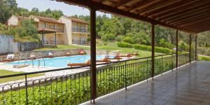 a view from the balcony of a house with a swimming pool at Habitat Villa Corfu in Dassia