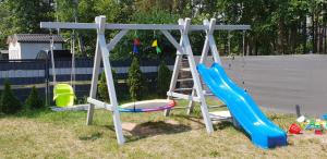 a playground with a ladder and a slide at Pobierowo Bracka 1 in Pobierowo