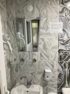 a bathroom with a sink and a mirror at SARIMESE OTEL in Demirci +8 photos