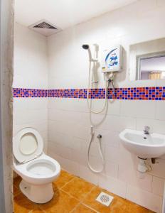 a bathroom with a shower and a toilet and a sink at 1st inn hotel subang in Subang Jaya