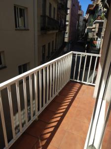 a balcony with a white railing on a building at Apartamentos A Casa da Herba in Redondela