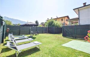 a row of lounge chairs in a backyard at Nice Home In Camaiore With Kitchen in Camaiore +14 photos