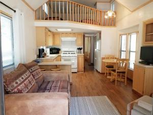 a living room with a couch and a kitchen at Circle K Ranch in Rico