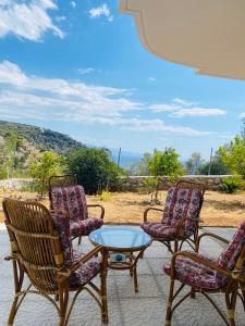 a group of chairs and a table on a patio at Mikro Amoni Beach Villa in Pefkali