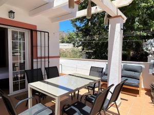 stół i krzesła na patio w obiekcie Azahara En Suite Casasol w mieście Nerja