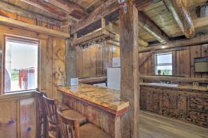 a kitchen with wooden walls and a counter with a refrigerator at Pet-Friendly Countryside Cottage with Fire Pit! in Fond du Lac