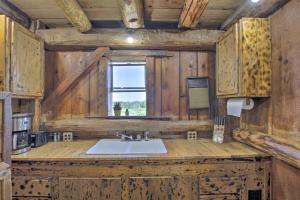 a kitchen with a sink and a window at Pet-Friendly Countryside Cottage with Fire Pit! in Fond du Lac