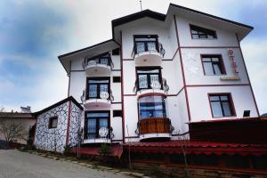 a white building with balconies on the side of it at SARIMESE OTEL in Demirci