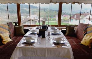 a long table with plates and glasses on top at SARIMESE OTEL in Demirci