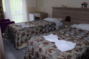 a hotel room with two beds with towels on them at SARIMESE OTEL in Demirci