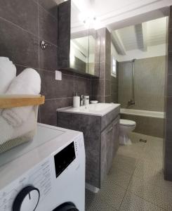 a bathroom with a sink and a toilet at Evgenia Seafront House in Skiathos