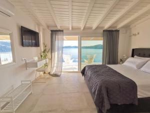 A bed or beds in a room at Evgenia Seafront House