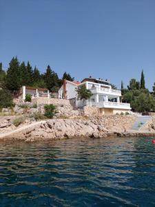a house on a rocky island in the water at Kuća za odmor SeaHouse in Karlobag