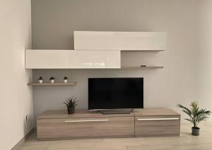 a living room with a flat screen tv on a cabinet at Shining house in Milan in Milan