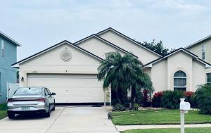 a car parked in front of a house with a garage at Ruskin FL private 2 bdrm 1 bath suite Common areas shared with host in Ruskin