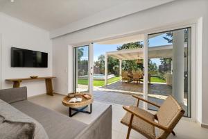 a living room with a couch and a table at Playia Villas I in Petrití