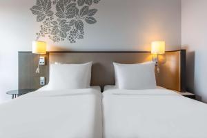 Rúm í herbergi á Radisson Blu Hotel Uppsala