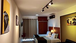 a hotel room with two beds and a window at Pacifico Apart Hotel in Santa Cruz de la Sierra