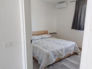 a bedroom with a bed in a white room at Villa Chirilú in Polignano a Mare