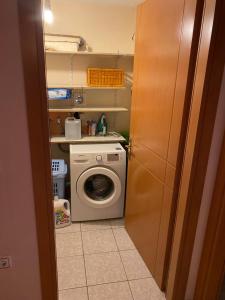 a laundry room with a washing machine and a washer at Voula’s dream house in Néa Péramos