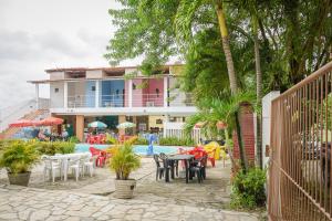 een resort met een zwembad en tafels en stoelen bij Passarela do Caranguejo PB in Conde