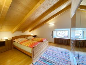 a bedroom with a bed and a large window at Loft Mountain Spirit in Livigno