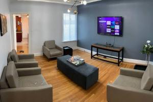 a living room with couches and a flat screen tv at Golden Gate Park Sweet Home- 3 Bedrooms in San Francisco