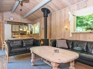 a living room with a couch and a table at 6 person holiday home in Silkeborg in Silkeborg