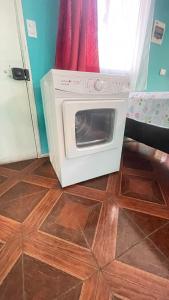 a microwave oven sitting on top of a wooden floor at Cabañas Don Pedro in Coihaique